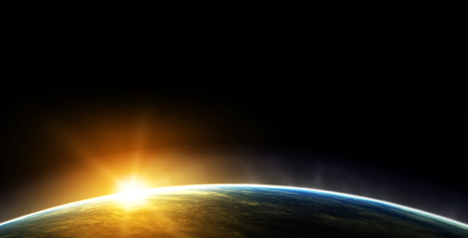 Sun rising over earth from space